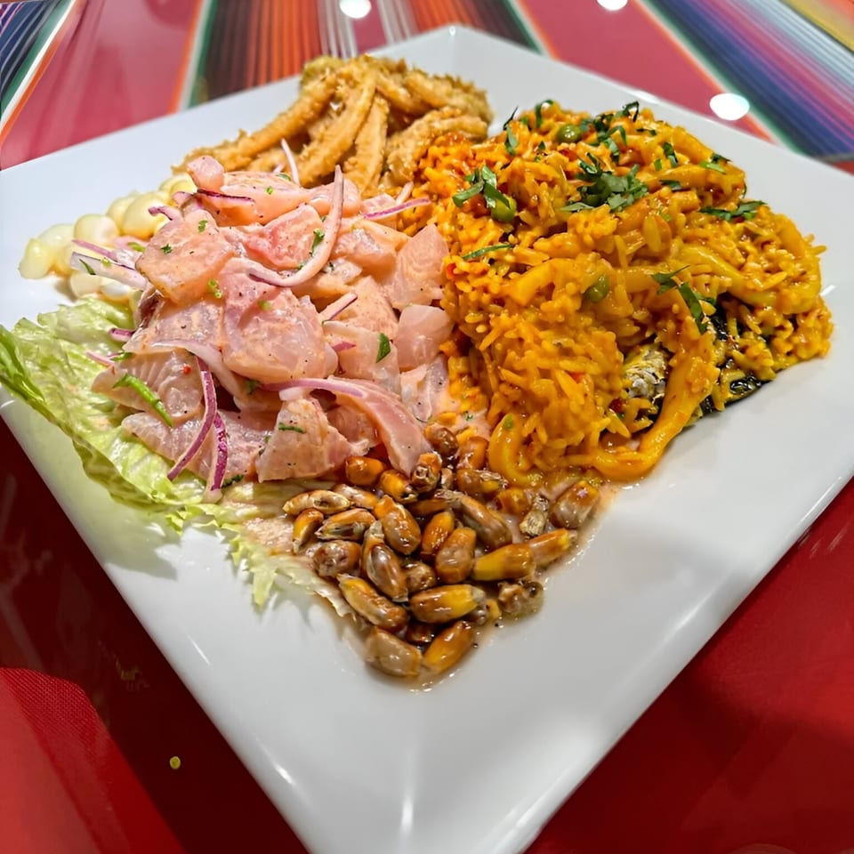 A Sabor Peruano platter with ceviche, fried calamari, arroz con mariscos, and toasted corn.