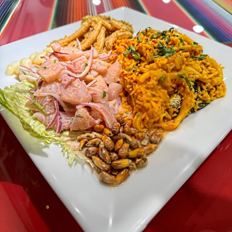 A Sabor Peruano platter with ceviche, fried calamari, arroz con mariscos, and toasted corn.