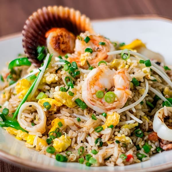 Peruvian arroz con mariscos, a seafood fried rice dish with shrimp, squid, and a scallop.